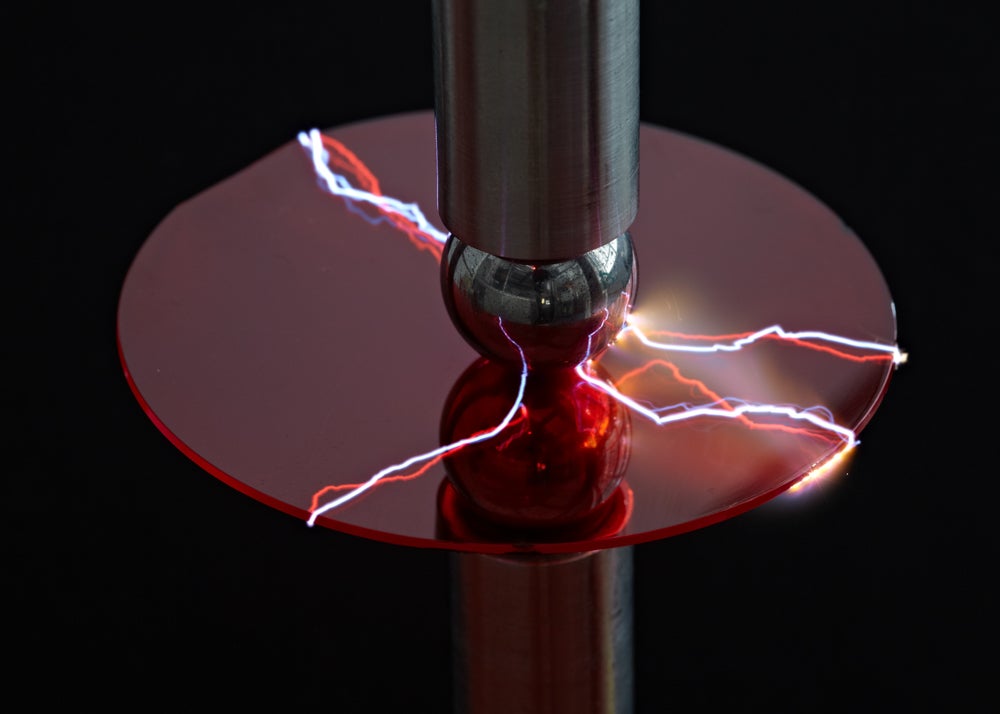 A machine using electricity to test a piece of plastic. 