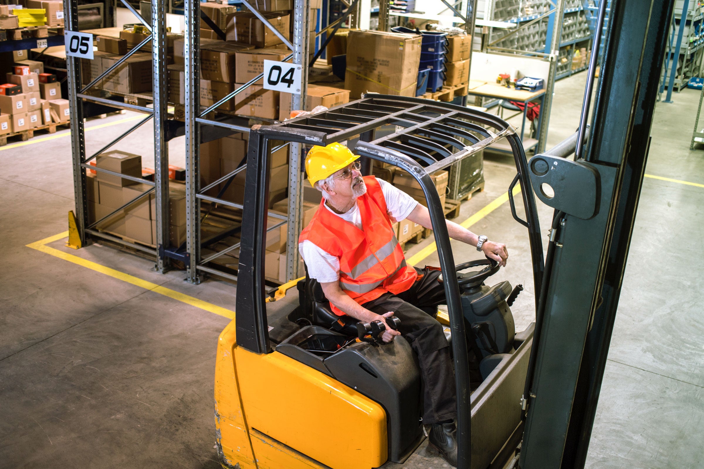 Worker driving a forklift