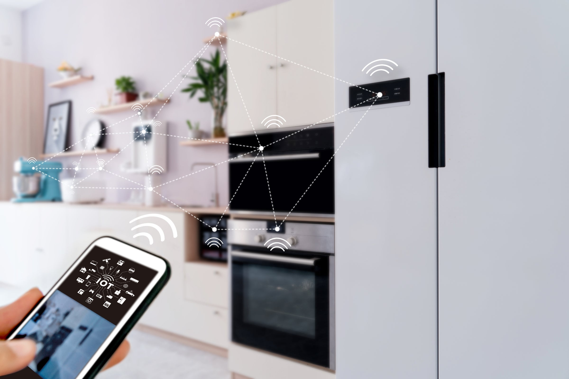 View of smart home from kitchen with appliances being operated by a mobile device.