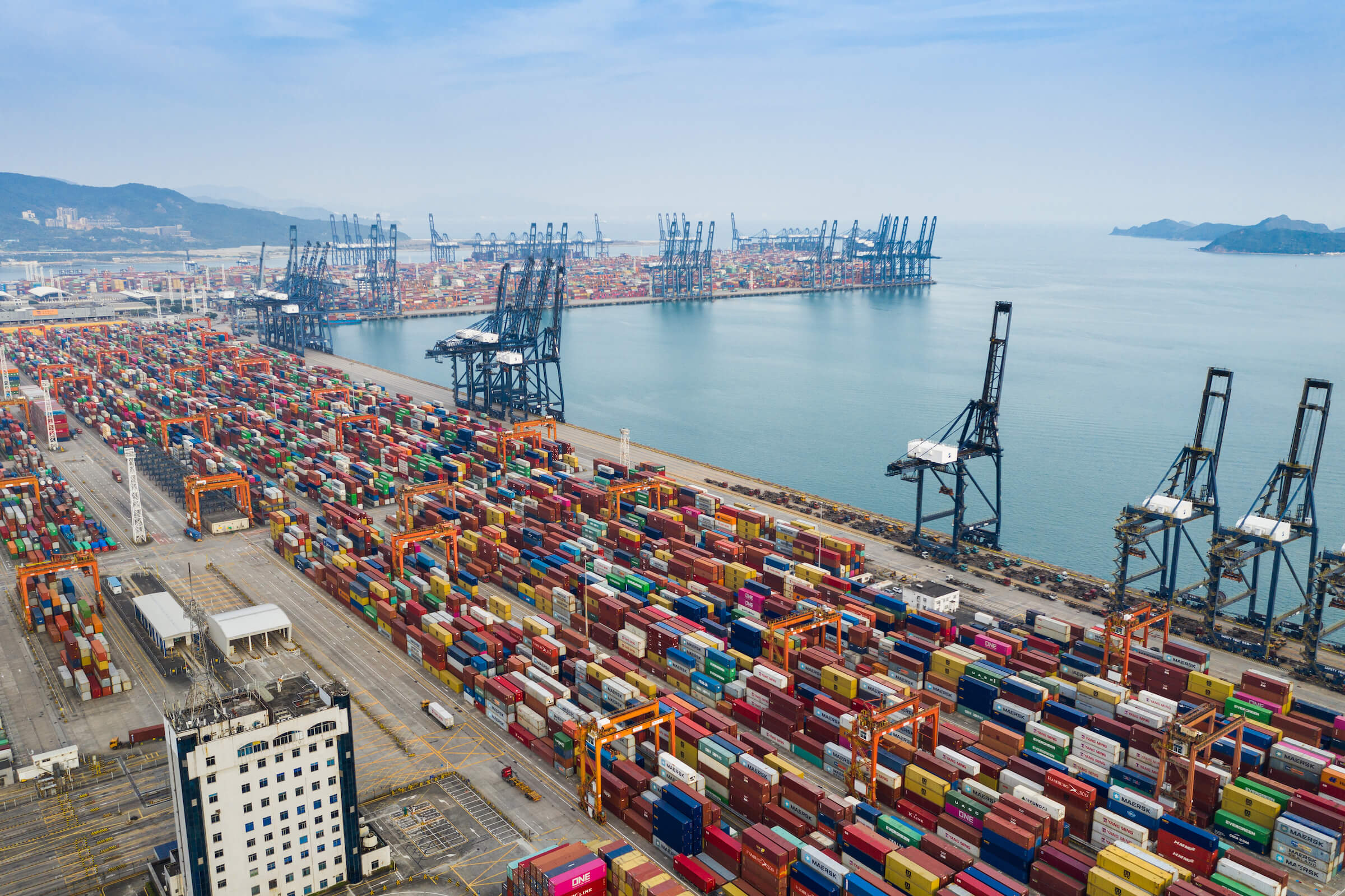 Rows of cargo carriers at a maritime shipping terminal