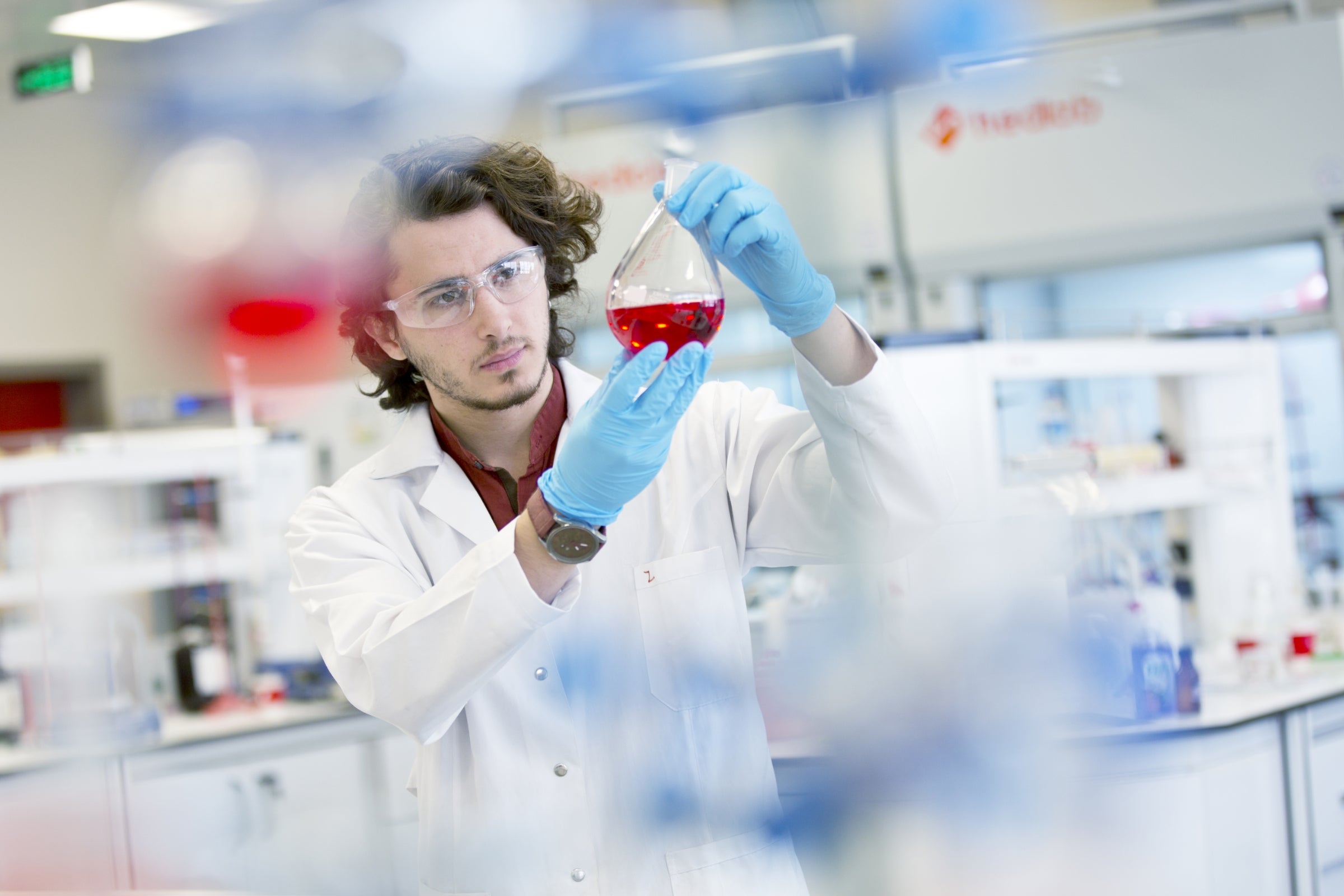 Chemistry research student working in laboratory.