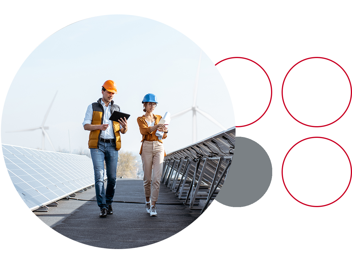 Two engineers walking down a row of solar panels