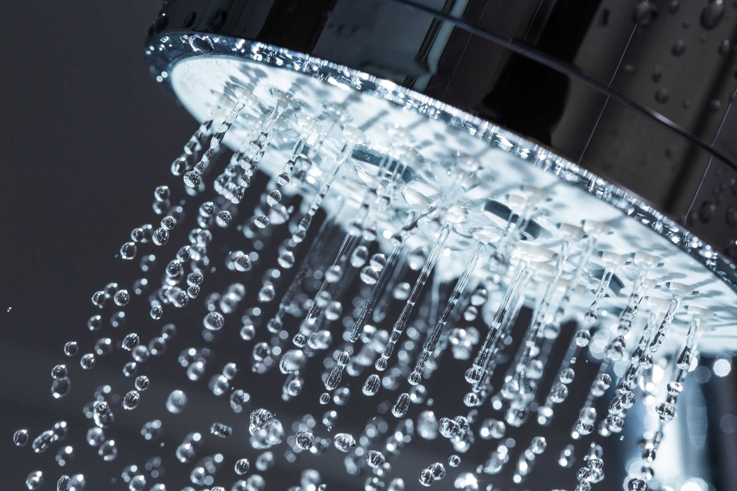 Closeup of a showerhead with water coming out