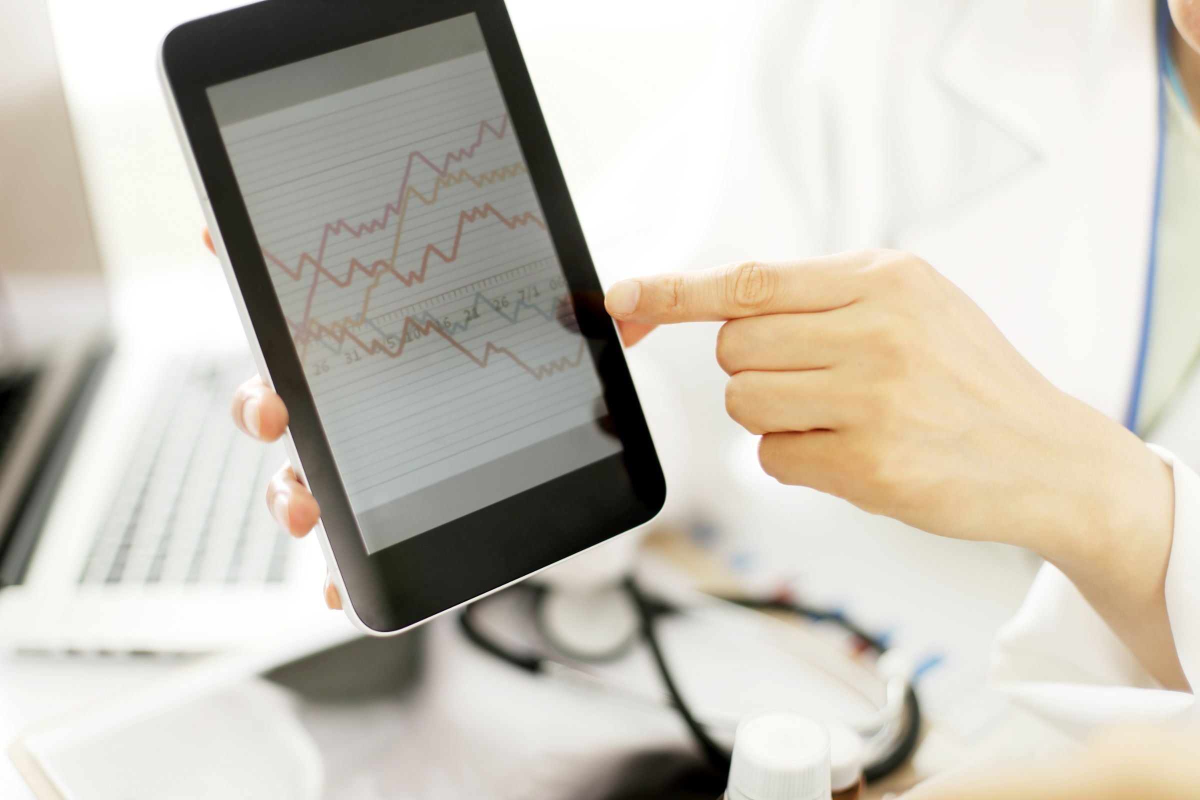 Doctor hands hold and show digital tablet pc to patient.