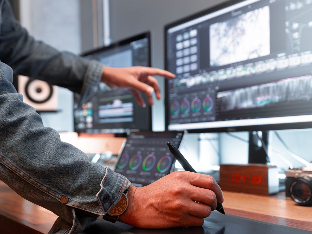 a person reviewing several medical computer screens