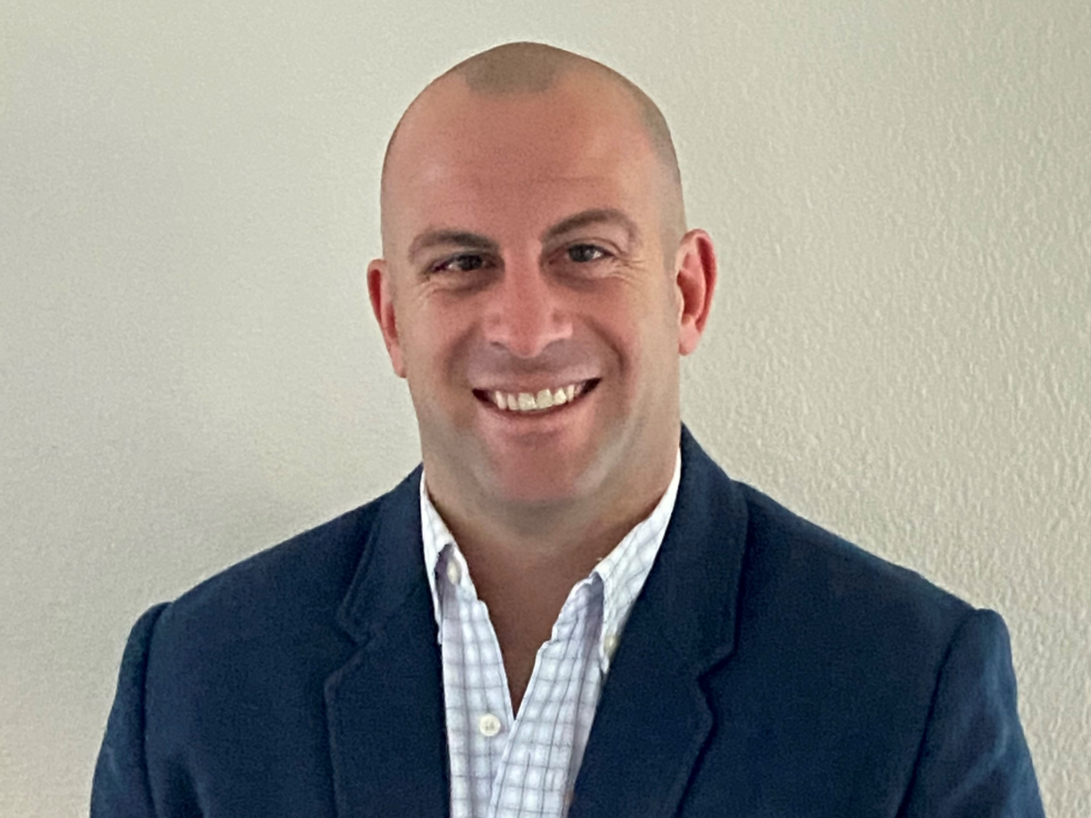 Portrait of Joel Ritschel wearing navy blue suit