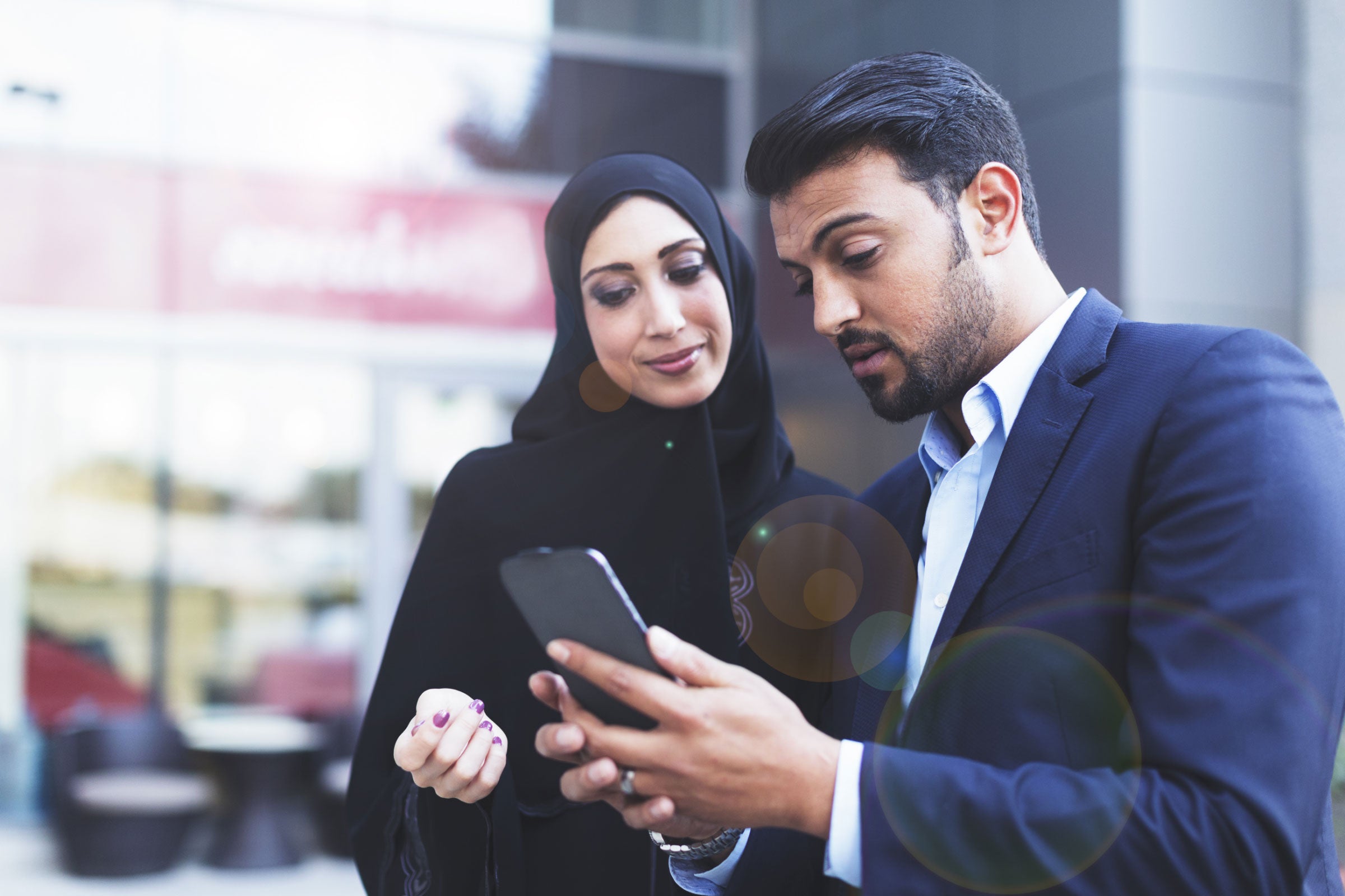 Two people looking at a cellphone