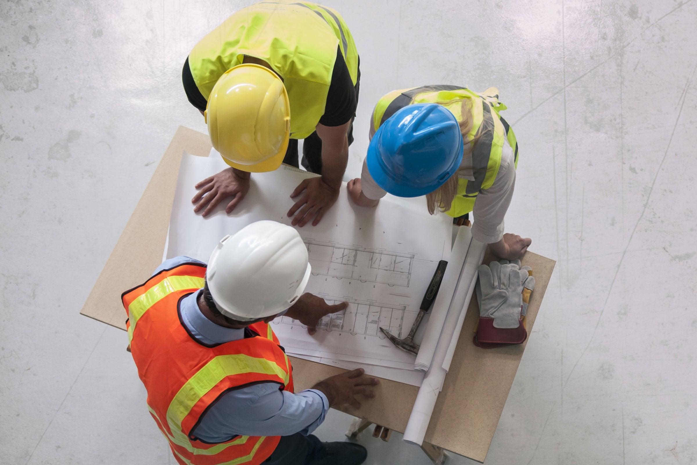 Contractors reviewing blueprints