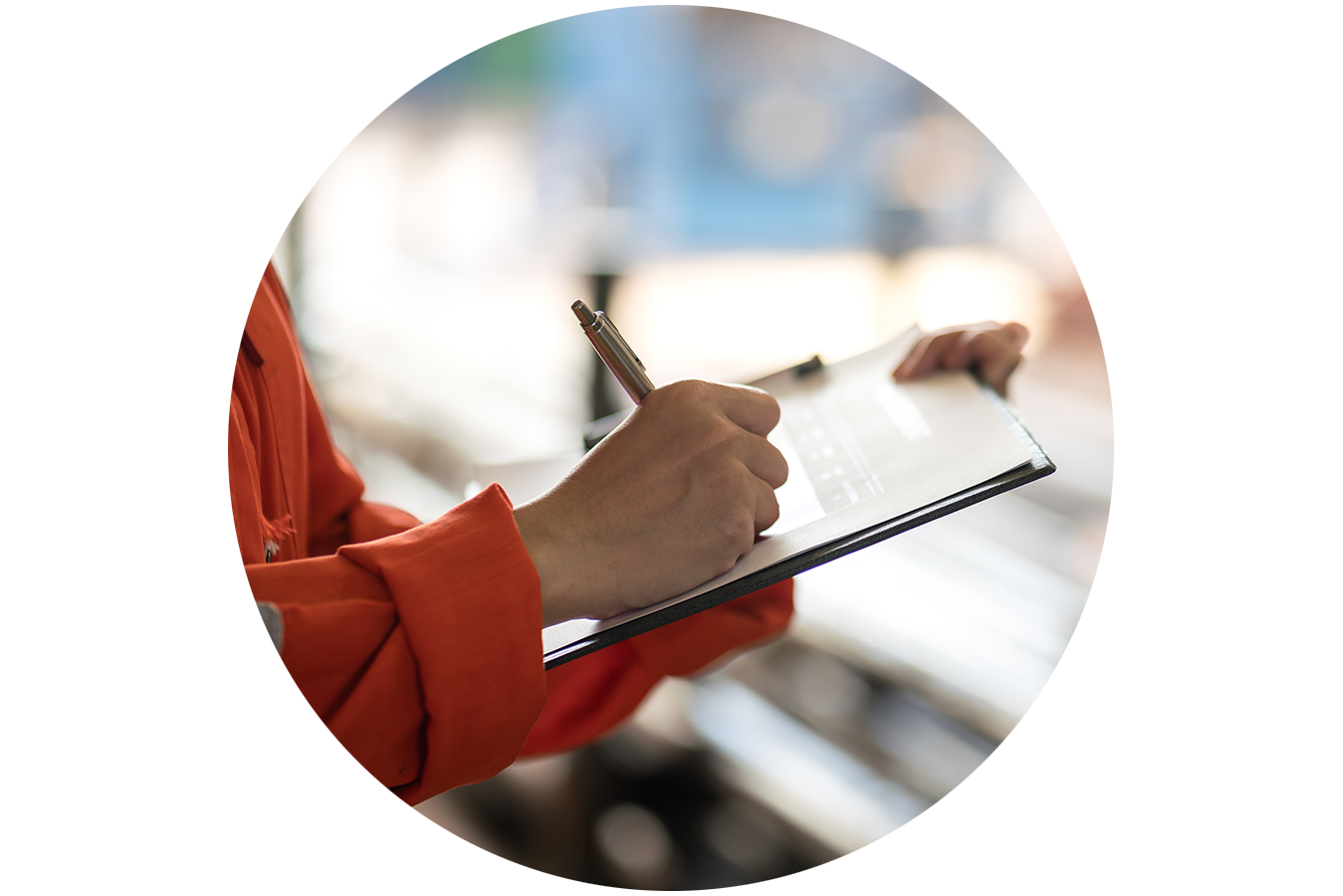 Inspector making notes on a clipboard