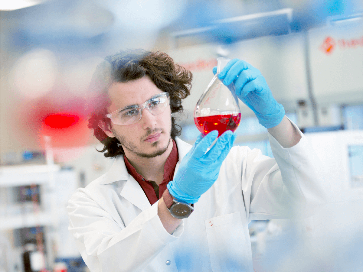 scientist inspecting liquid in a flask