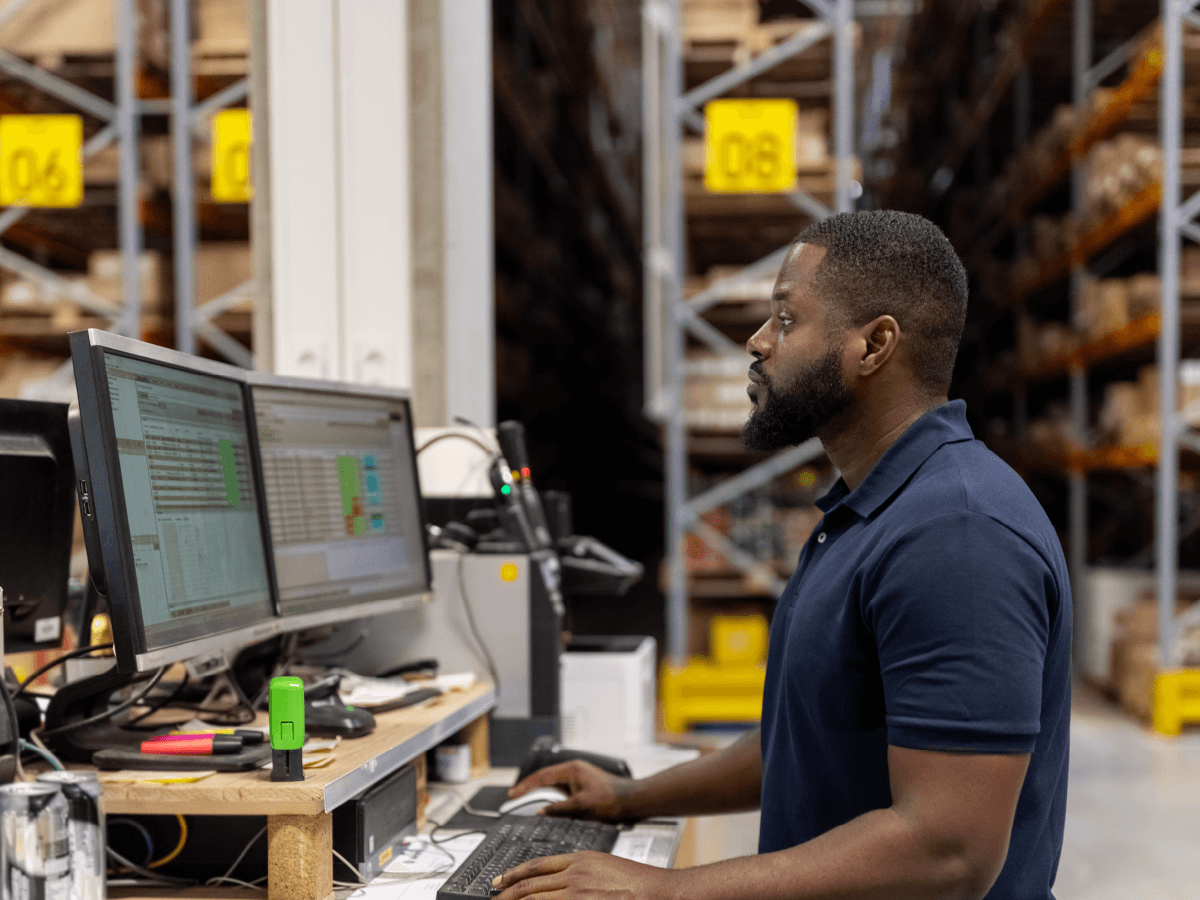 man at computer in factory