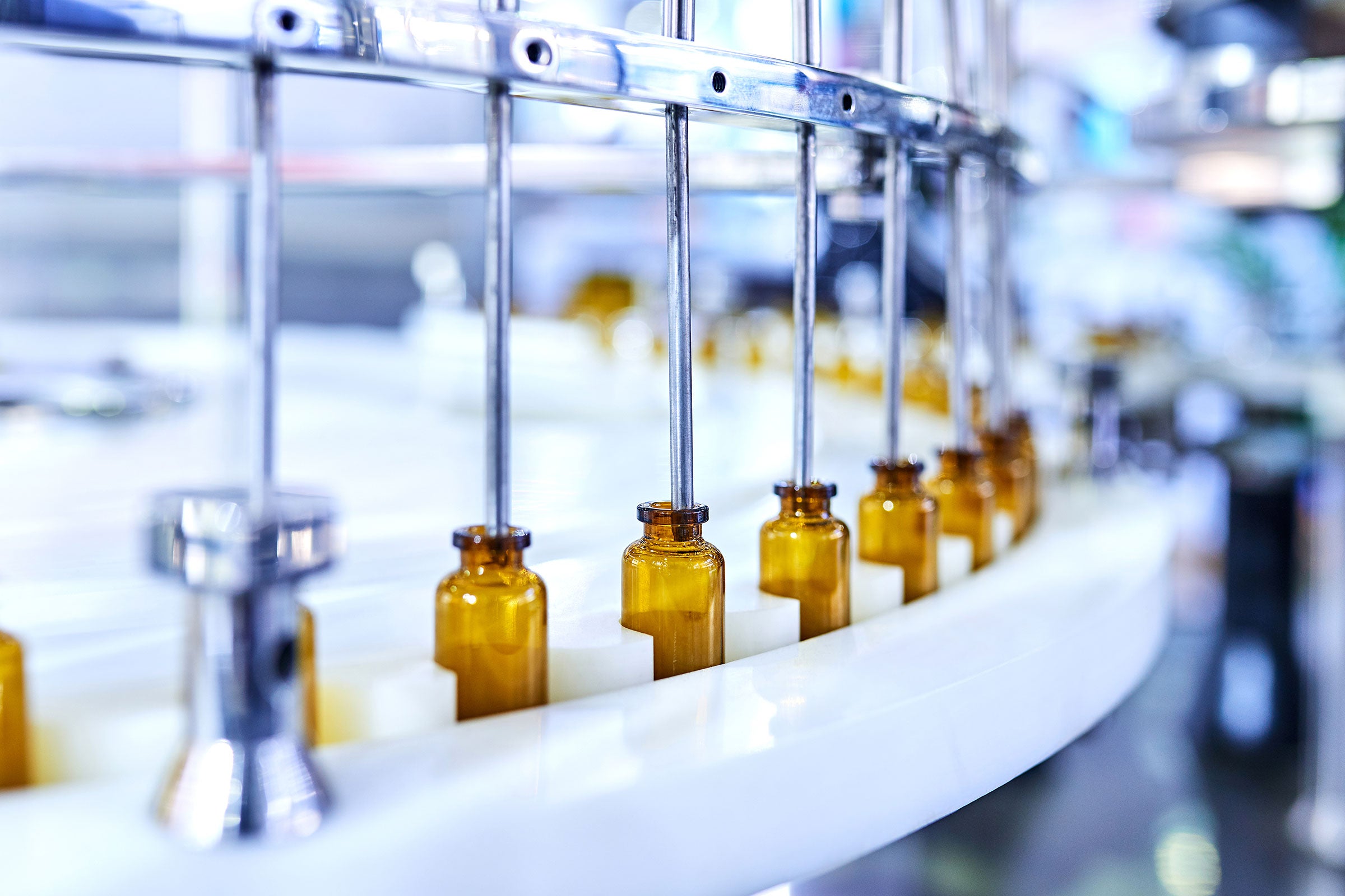 Brown medicine glass bottles on a production line