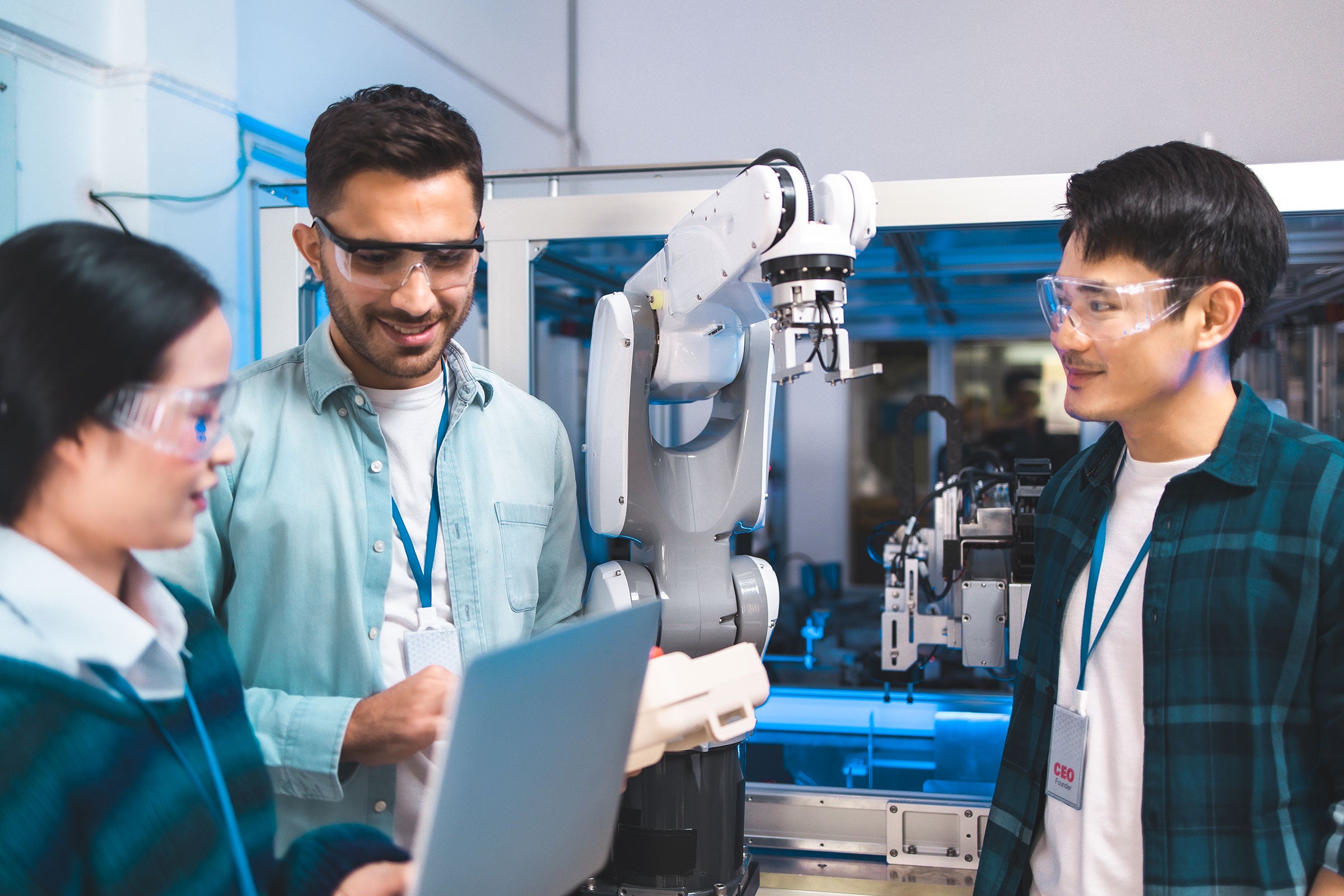 Team of engineers conducting an experiment with robotic arms