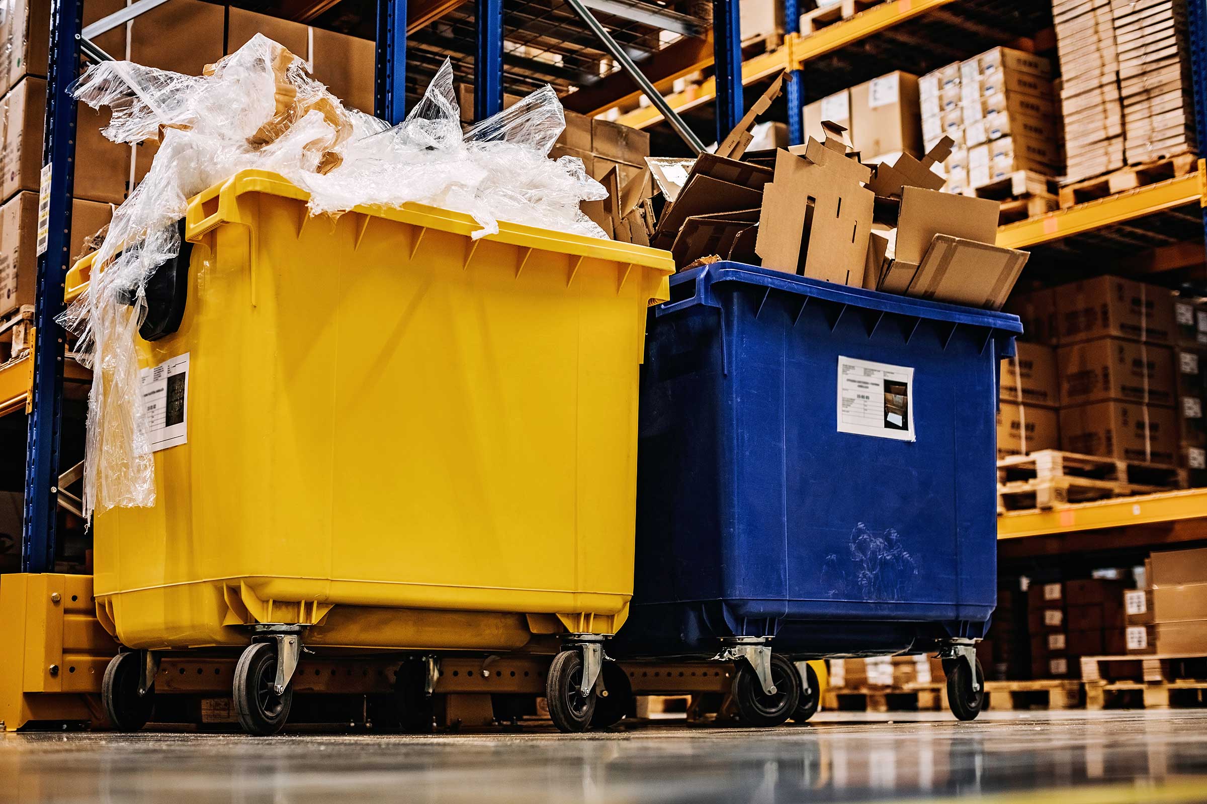 Two large recycle bins inside a warehouse