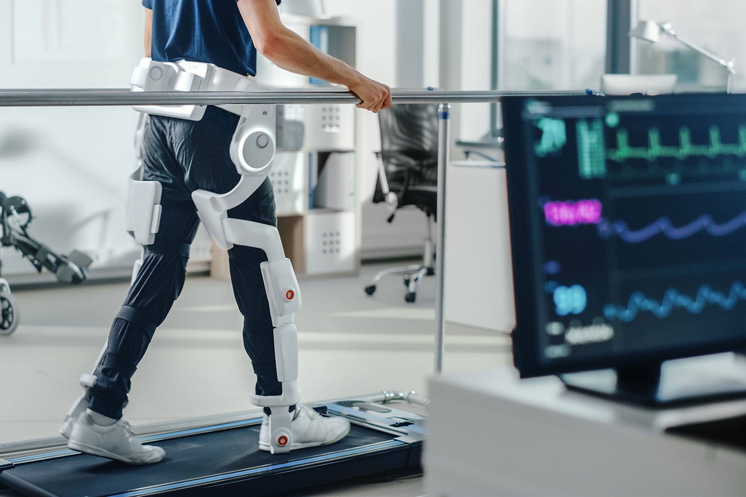 Patient with injury walks on a treadmill while wearing advanced robotic exoskeleton legs