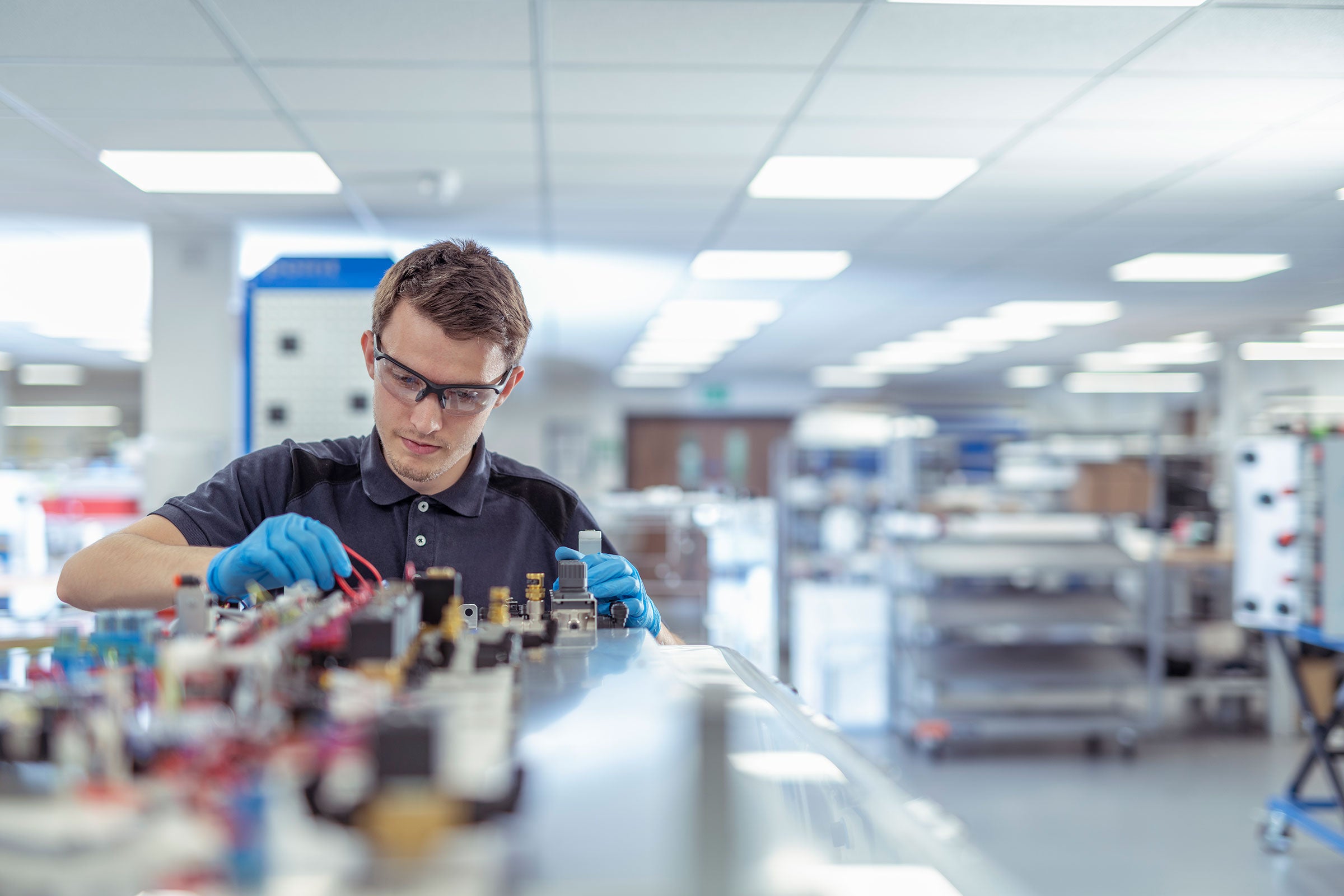 Engineer working on medical electronics machinery in a manufacturing factory