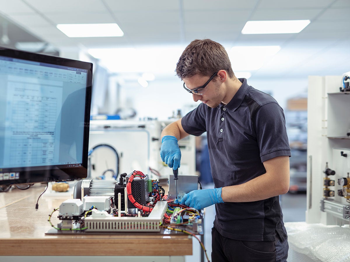 Engineer assembling parts in a medical electronics machinery manufacturing factory