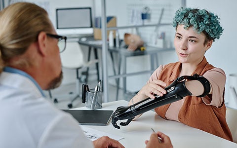 A patient discusses a prosthetic limb with the doctor