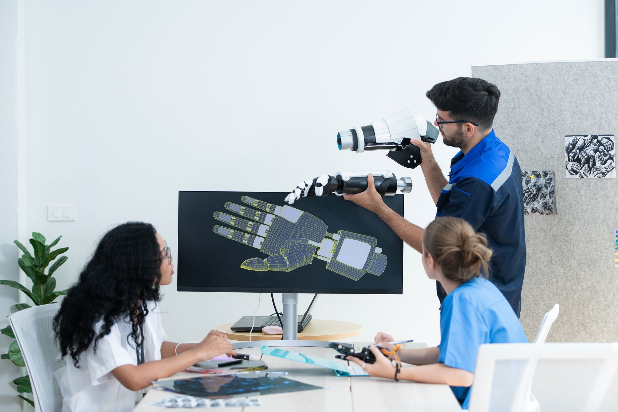 Engineer showing a robotic arm's design in a presentation to doctors