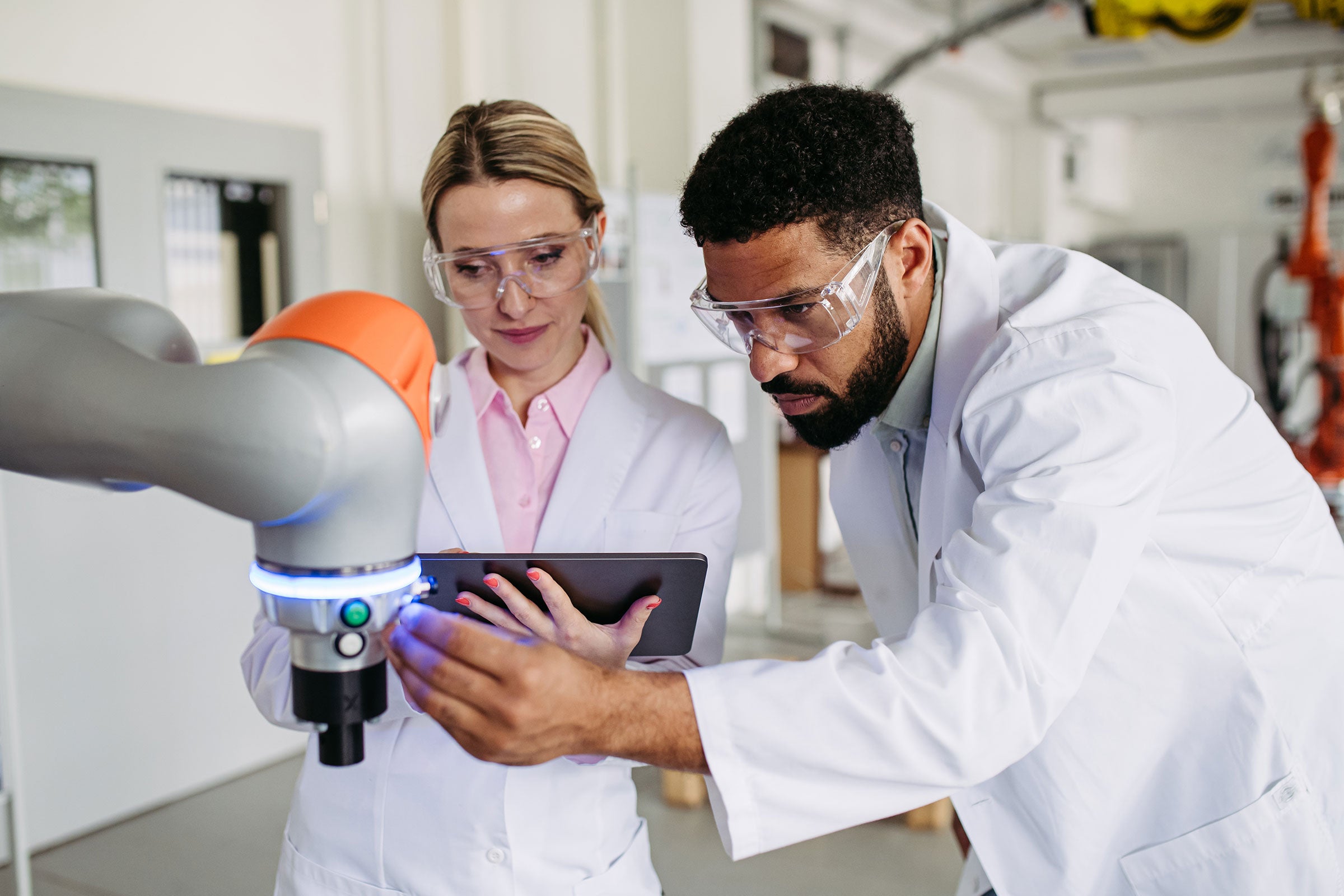 Two engineers reviewing lab equipment