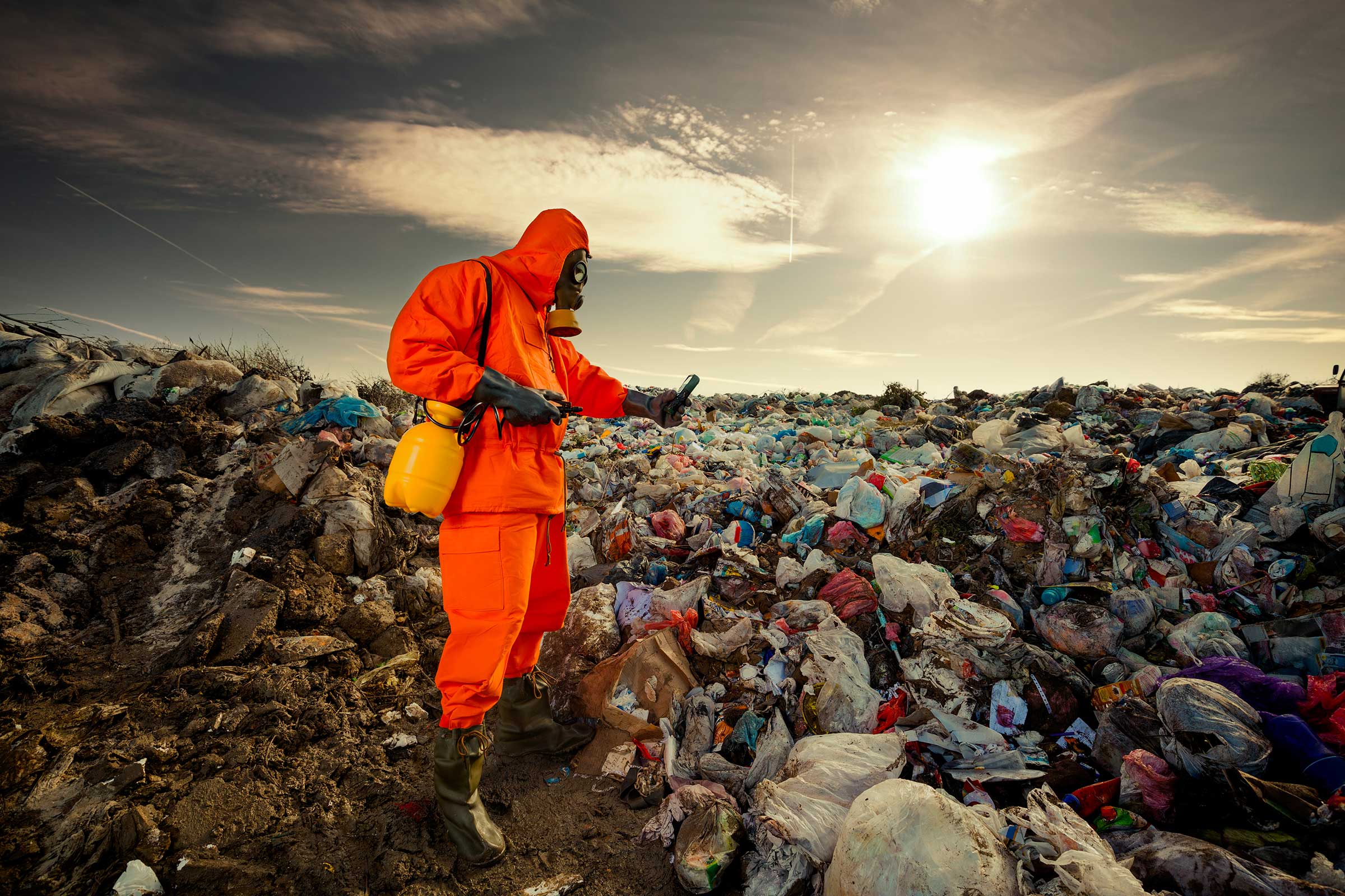 Person in Hazmat suit taking reading at a landfill