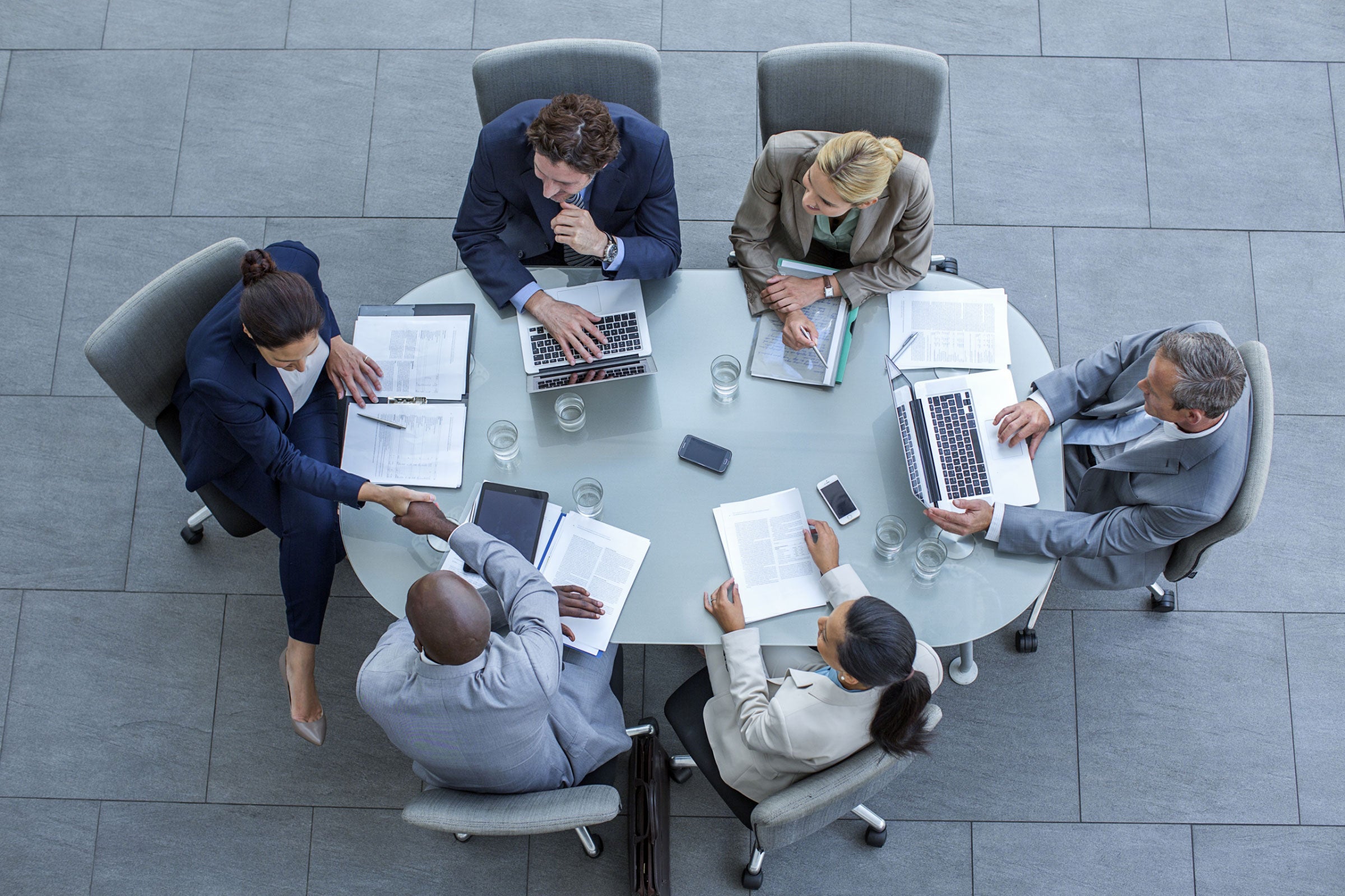 Overhead view of business people sitting around a conference table while working