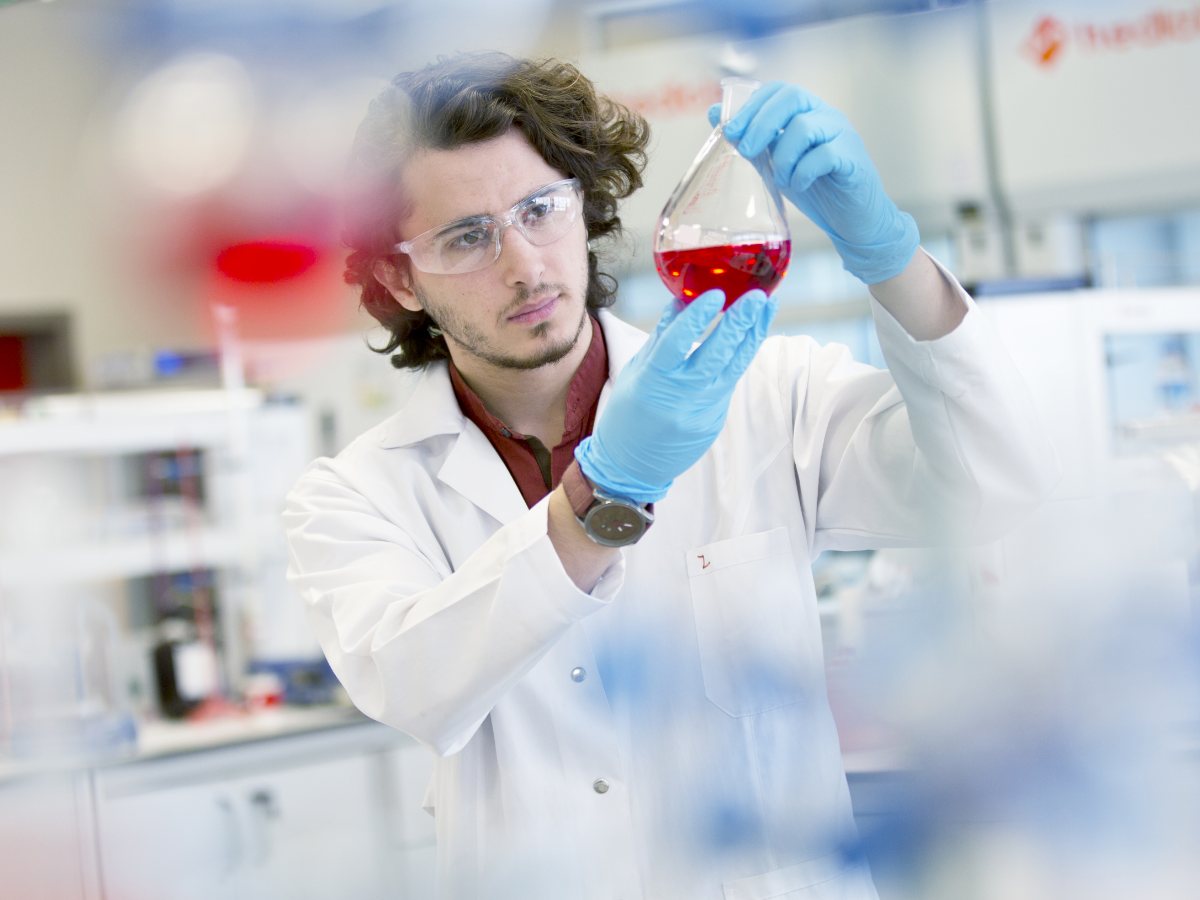 scientist inspecting liquid in a flask