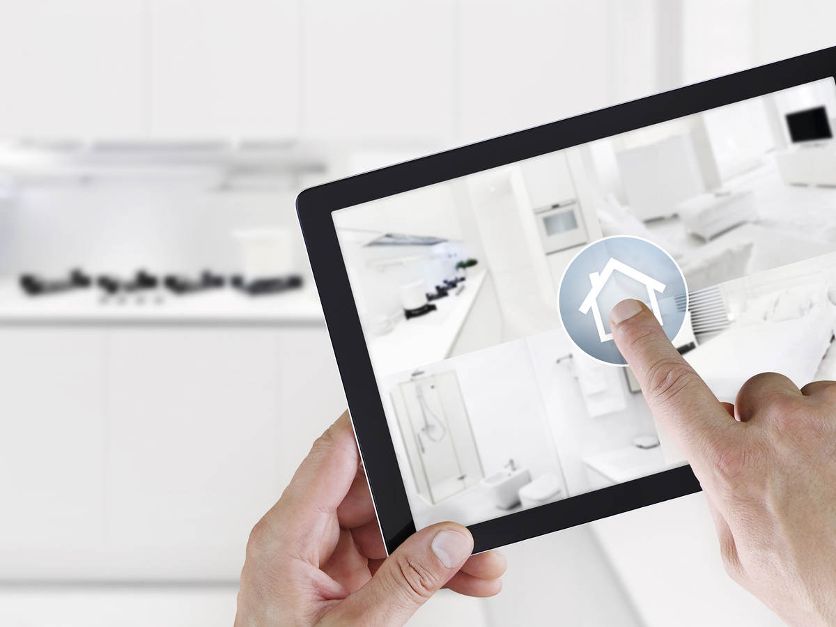 A person using a smart app on a tablet to control the SmartHome