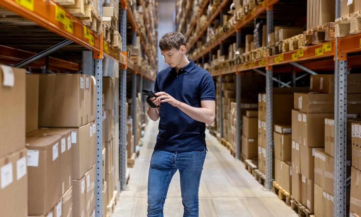 warehouse stocker checking his scanner