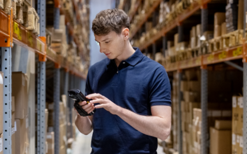 man with scanner in warehouse