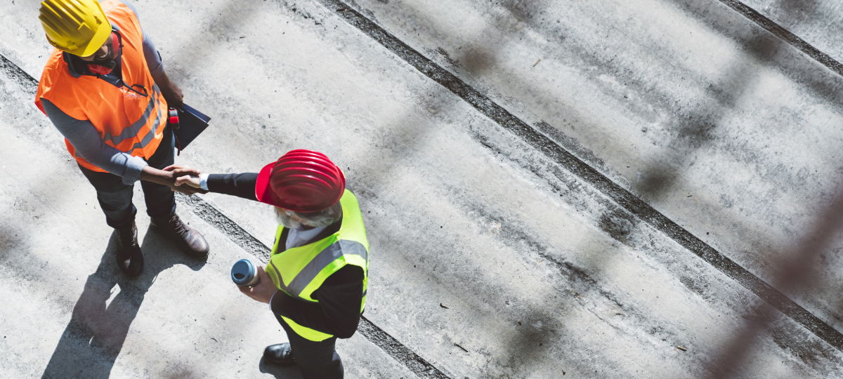 two construction site workers in hard hats