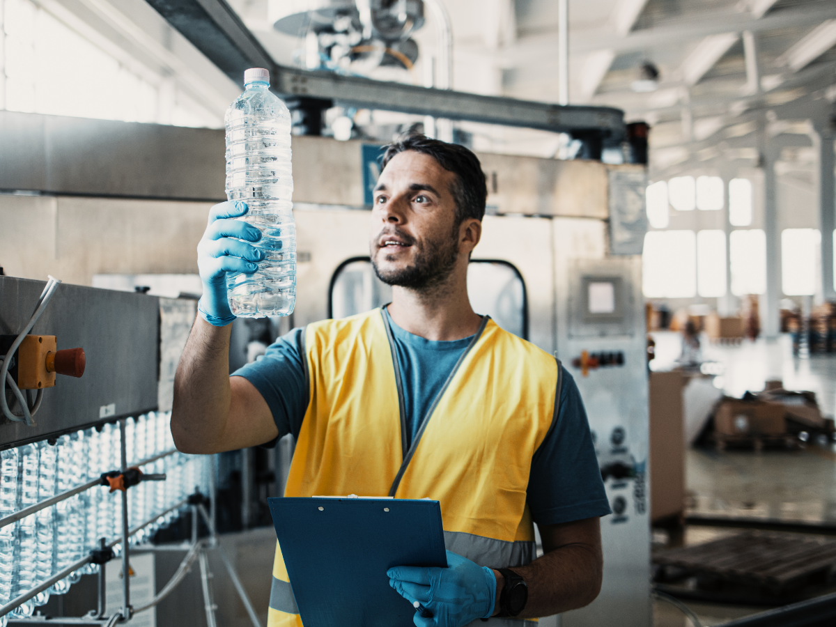 person in facility inspecting water bottle