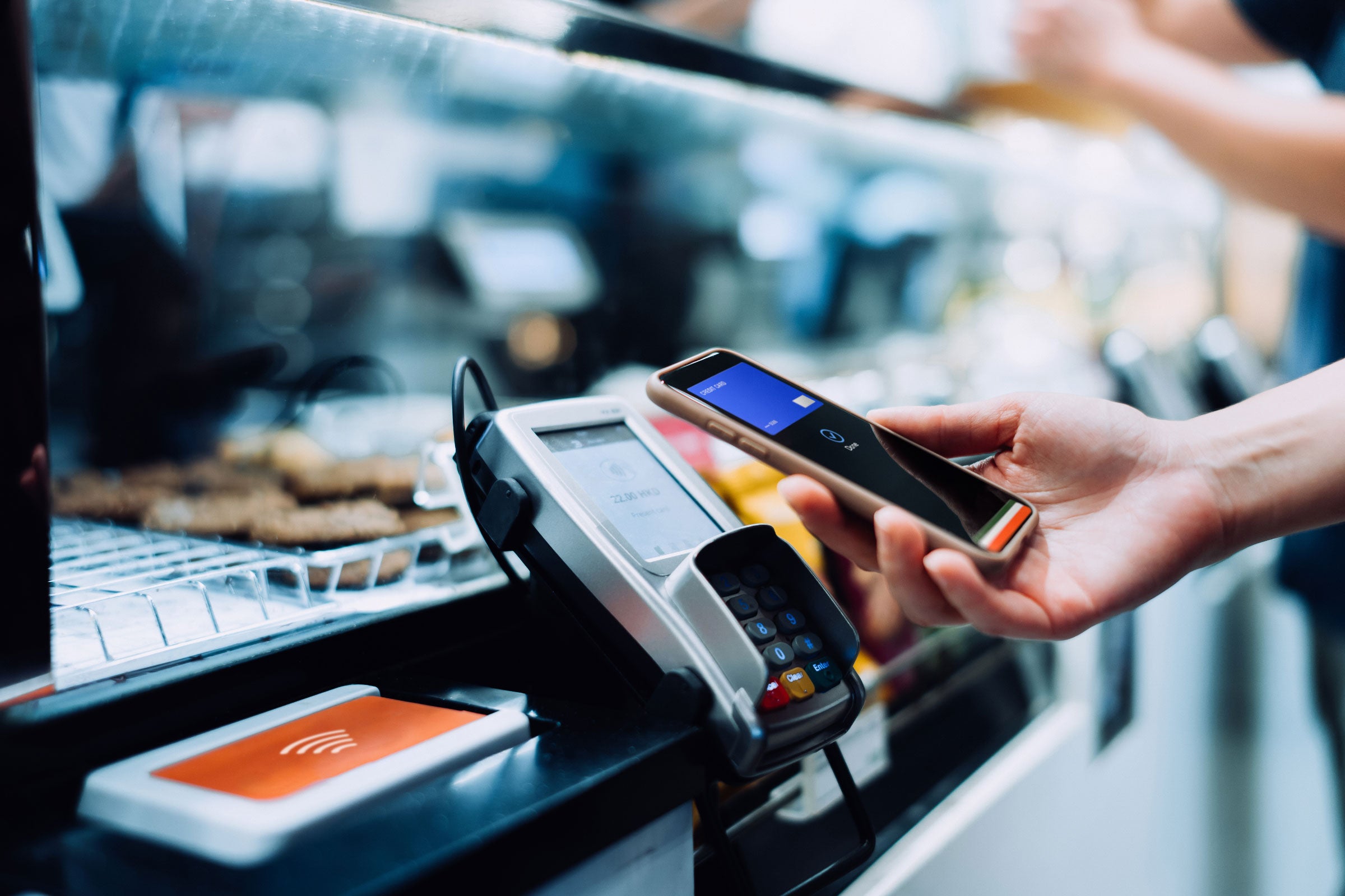 A person using a mobile phone to make a payment