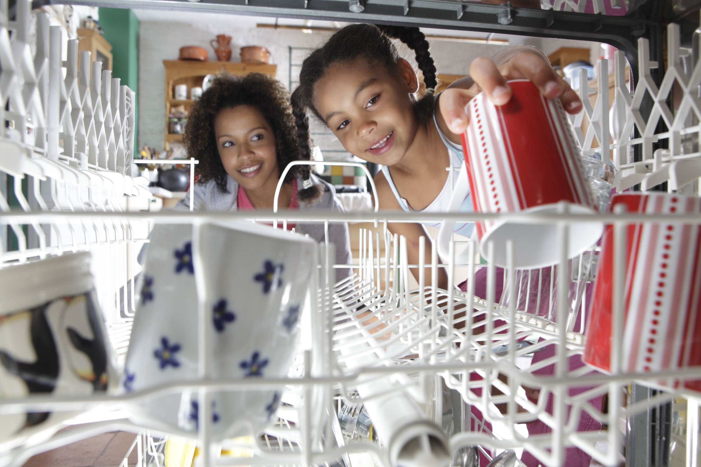 Mother and child looking into a dishwasher