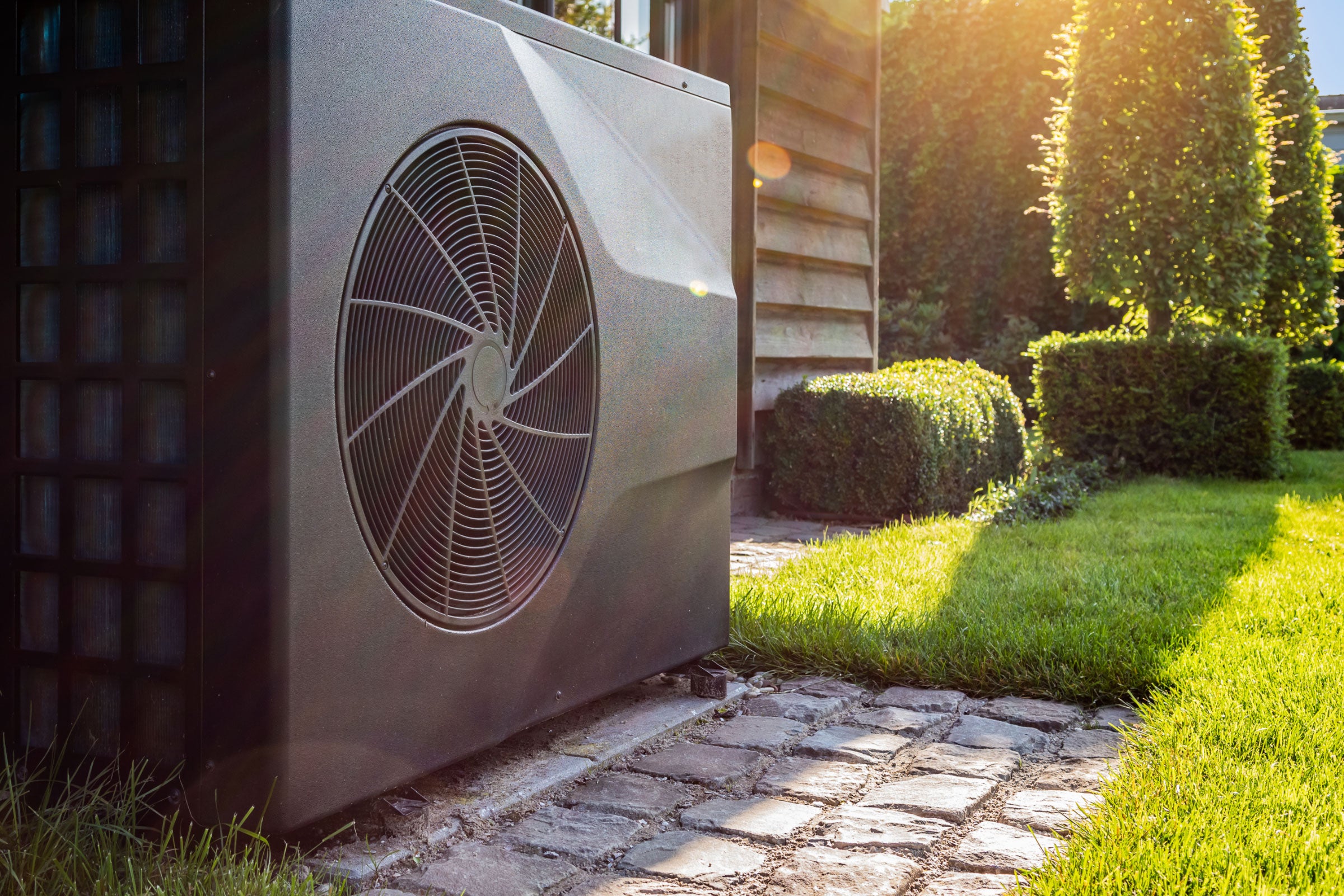 An air conditioning unit in a beautiful yard