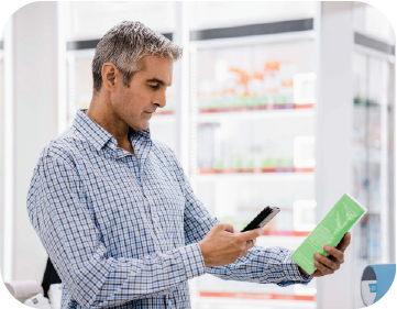 man scanning object with smart device