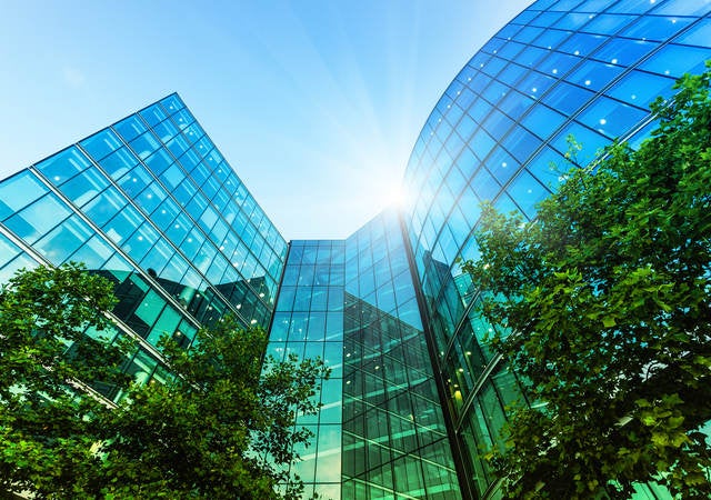 Modern skyscrapers and lush trees