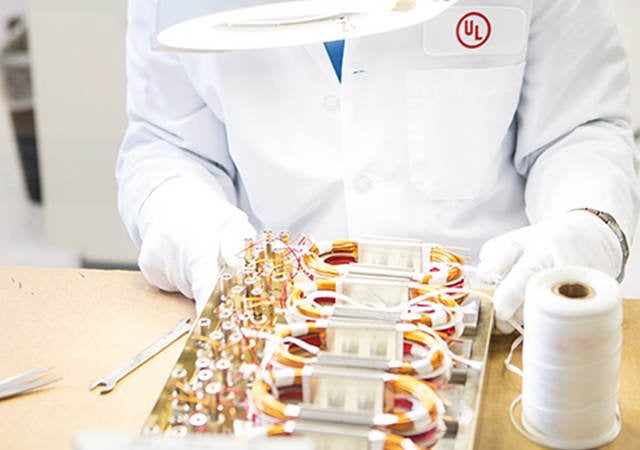 A UL laboratory worker examining a wire board. 