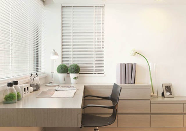 Modern office space with windows, desk and chair