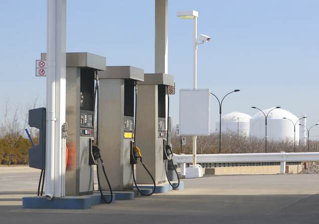 Three pumps at a gas station. 