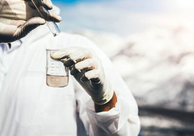 Close-up of person testing water sample.