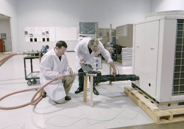 Two UL engineers testing an HVAC unit in a laboratory