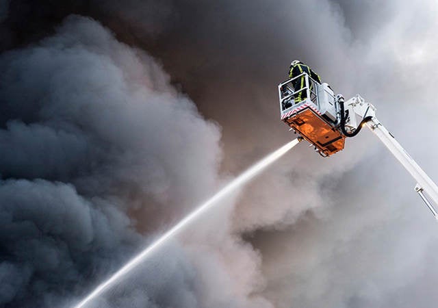 Firefighter spraying water on a fire