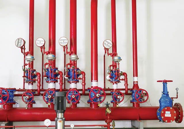 Red pumps and valves in a fire station. 