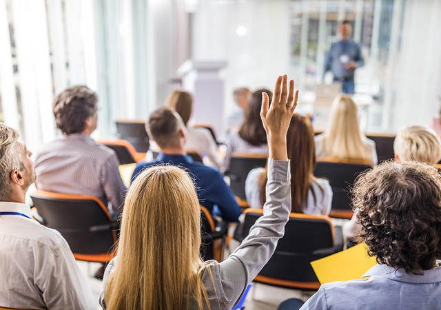 Business people attending a seminar in board room