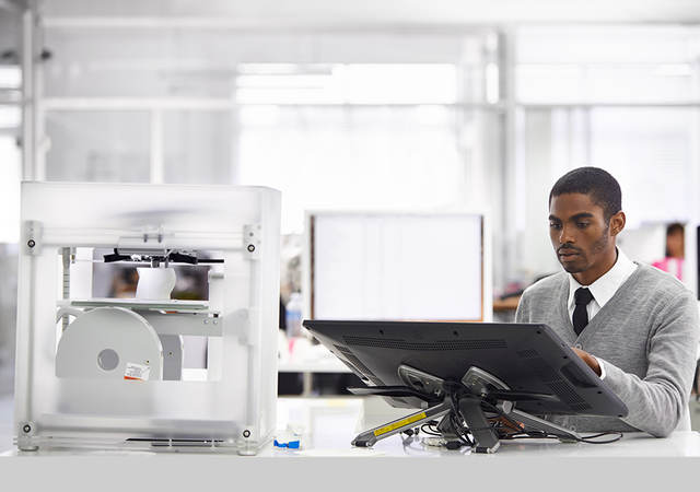 Man designing a product being printed on a 3D printer