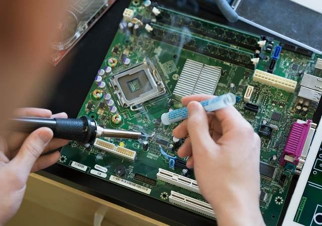 Person soldering a circuit board