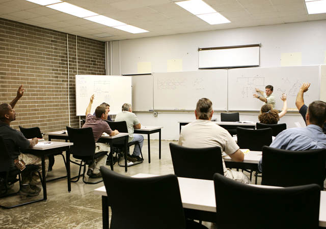 A classroom of individuals learns more about hazardous location training. 