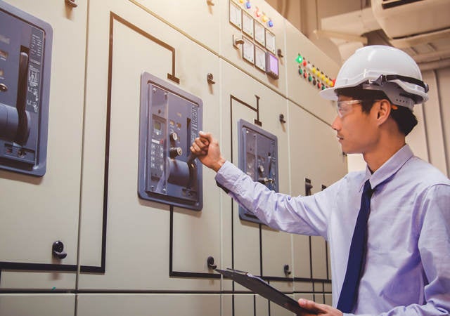 Worker testing a switch