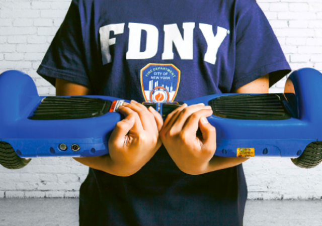 Person with FDNY tshirt holding a hover board